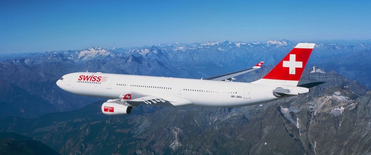 Swiss airplane flying over high mountains