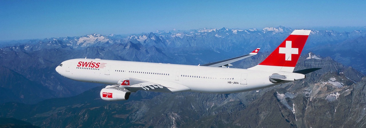 Swiss airplane flying over high mountains