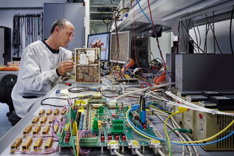 Employee working on a complex part of a space part